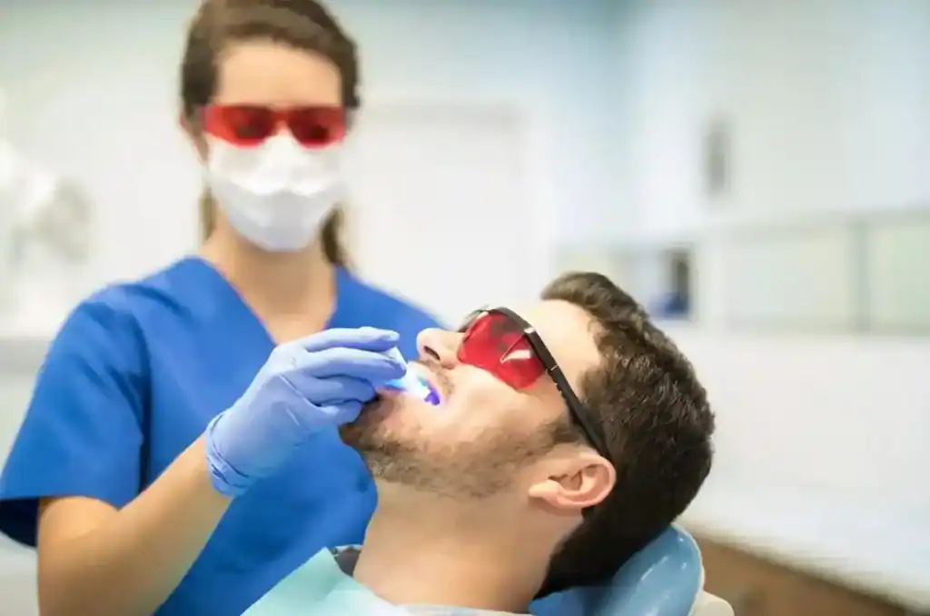 Close-up of Zoom Laser Teeth Whitening procedure being administered to a male patient Coventry